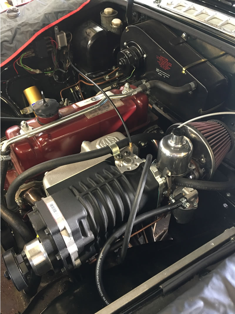 Supercharger being fitted to an MGB